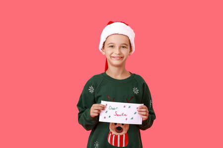 Little boy with letter to Santa on color backgroundの写真素材