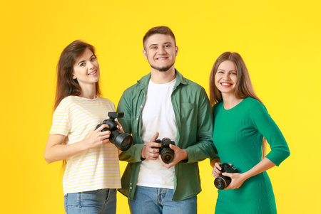 Group of young photographers on color backgroundの写真素材