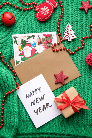 Beautiful greeting cards for New Year celebration, gift and sweater, top viewの写真素材