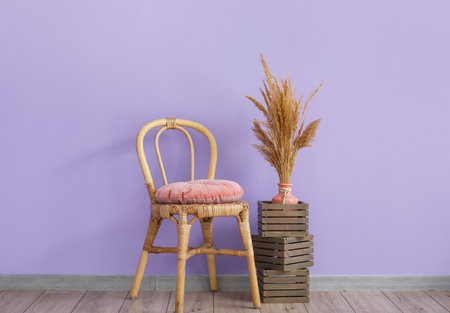 Chair and wooden boxes near color wall in roomの写真素材