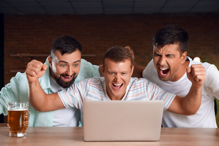 Happy men after winning their sports bet in pubの写真素材