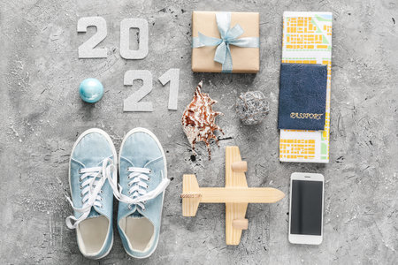 New Year composition with gift, passport, map and airplane on gray backgroundの写真素材