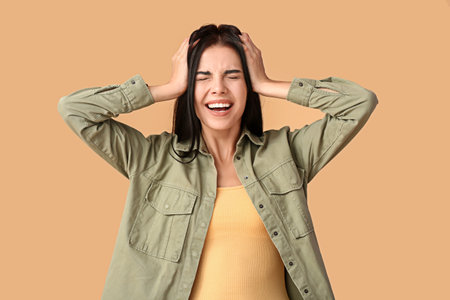 Stressed young woman on color background