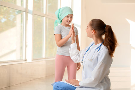Doctor and little girl in clinic. Childhood cancer awareness conceptの写真素材