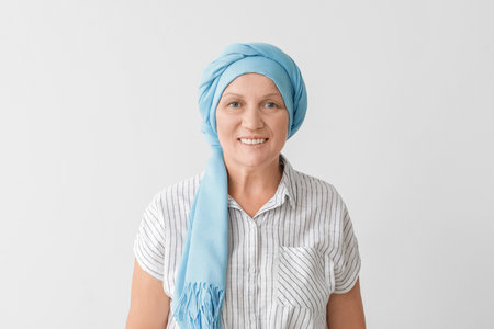 Happy mature woman after chemotherapy on light backgroundの写真素材