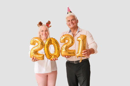 Elderly couple with figure 2021 on light background. new year celebrationの写真素材