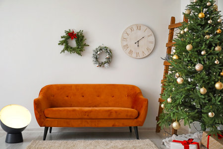 Beautiful Christmas wreaths and tree in interior of living room