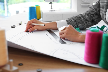 Female fashion designer working in studio, closeup