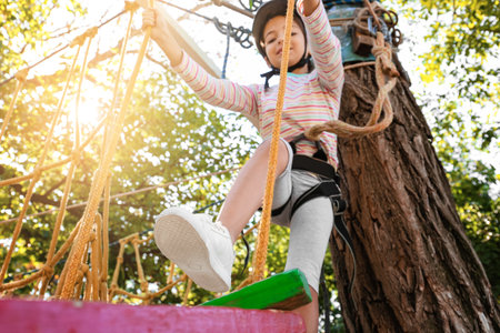 little girl climbing in adventure parkの写真素材