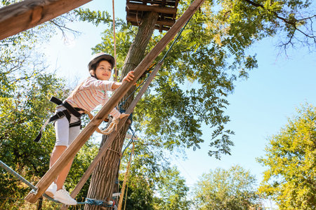 little girl climbing in adventure park