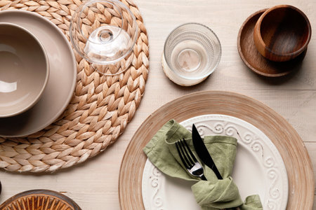 Stylish table setting with cutlery and plates on white wooden backgroundの写真素材