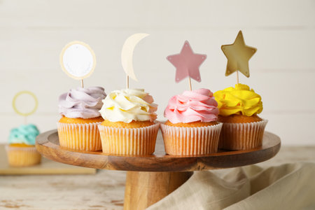 Tasty cupcakes with stylish toppers on wooden backgroundの写真素材