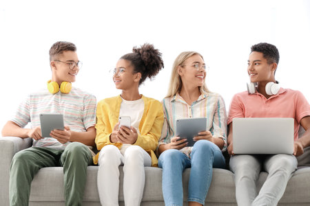 Teenagers with different devices at home