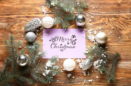 Beautiful composition with Christmas greeting card on wooden backgroundの写真素材
