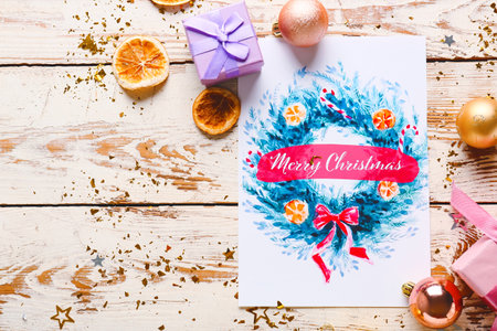 Beautiful composition with Christmas greeting card on wooden backgroundの写真素材