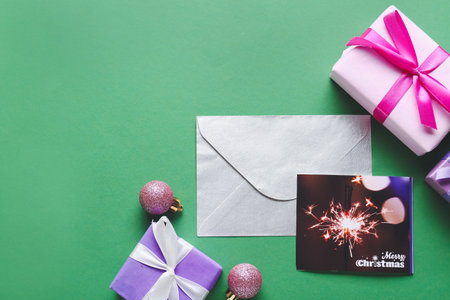 Beautiful composition with Christmas greeting card on color background