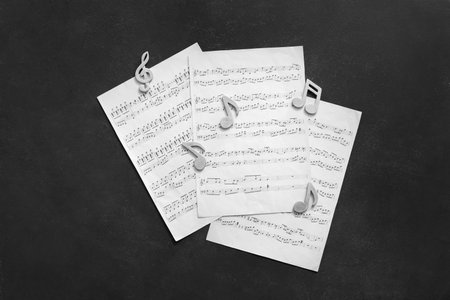Music sheets with notes on dark backgroundの写真素材