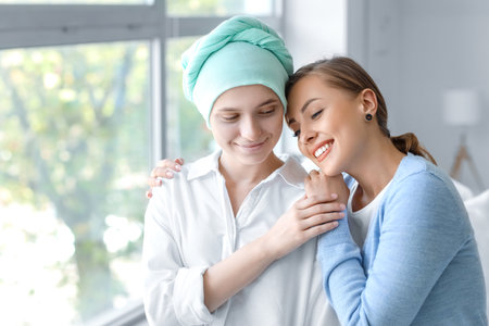 Woman her visiting sister after chemotherapy in clinic