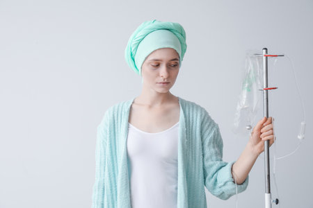 Woman undergoing chemical therapy course against gray background