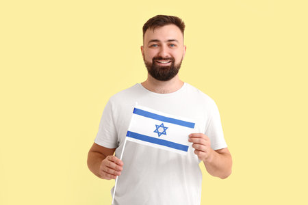 Man with the flag of Israel on color backgroundの写真素材