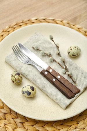 Table setting with Easter eggs and pussy willow branches, closeup