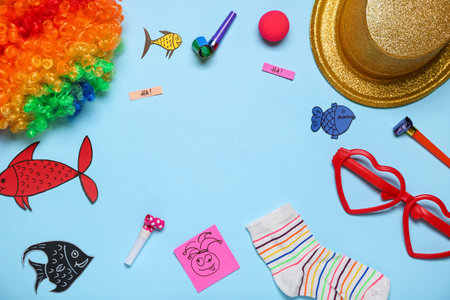 Frame made of party decor, sock and paper fishes on color background. April Fool's Day celebrationの写真素材