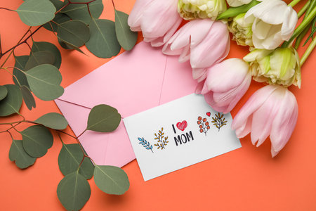 Composition with greeting card, eucalyptus branches and flowers on color background, closeup....