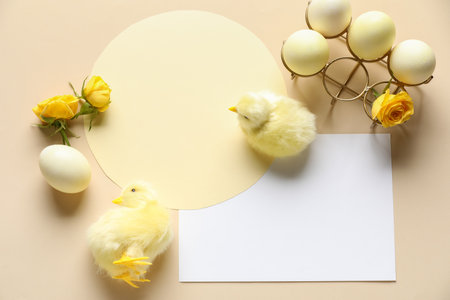Blank greeting cards, Easter eggs, rose flowers and baby chickens on beige backgroundの写真素材