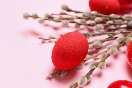 Painted Easter eggs and willow branches on pink background, closeupの写真素材