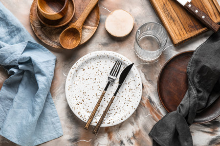 Beautiful table setting with wooden plates on grunge backgroundの写真素材