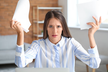 Stressed young woman at homeの写真素材