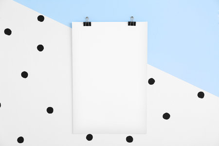 Blank poster hanging on color wallの写真素材