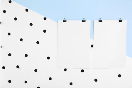 Blank posters hanging on color wallの写真素材