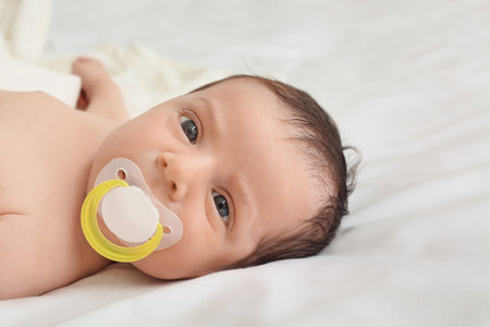 Cute little baby lying on bed