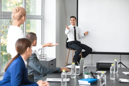 Businessman giving presentation during meeting in officeの写真素材