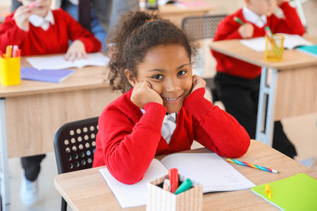 African-American schoolgirl during lesson in classroomの写真素材
