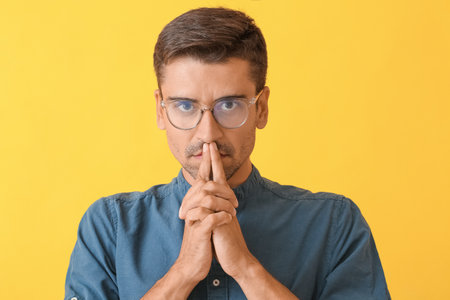 Portrait of thoughtful young man on color backgroundの写真素材