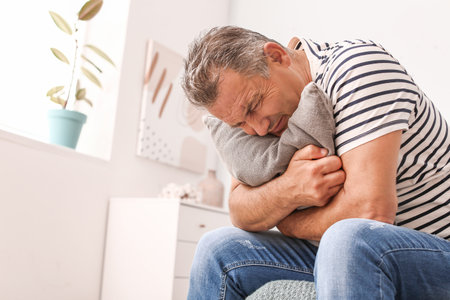 Stressed mature man at homeの写真素材