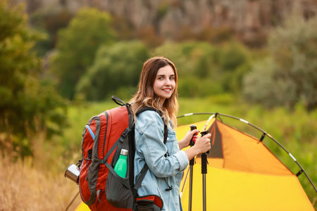 Young female tourist near tent in countrysideの写真素材
