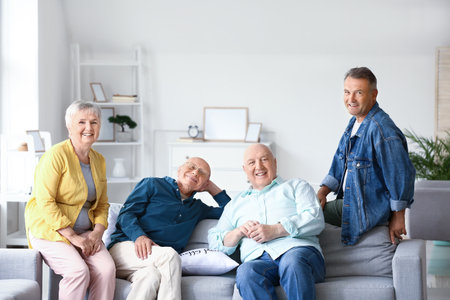 senior people sitting on sofa at home
