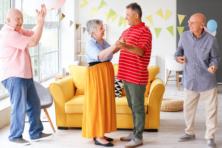 senior people celebrating birthday at homeの写真素材