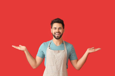 Young man showing something on color backgroundの写真素材