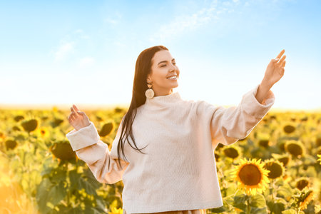 beautiful young woman in sunflower fieldの写真素材