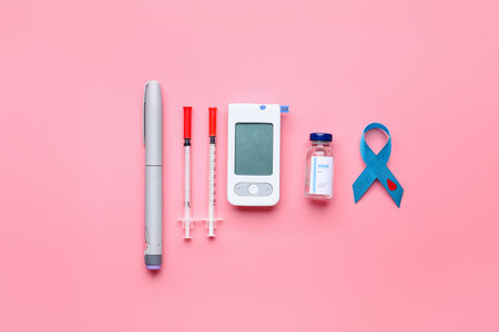 Awareness ribbon with insulin, syringes and glucometer on color background. Diabetes conceptの写真素材