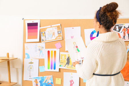 Female fashion designer working in studioの写真素材