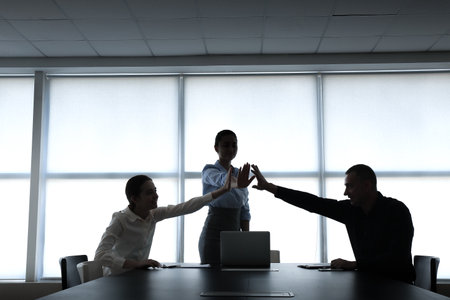 Silhouettes of business people in office