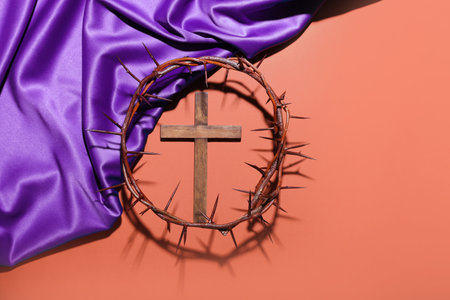 Cross with crown of thorns and purple fabric on red background. good friday conceptの写真素材