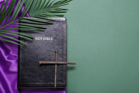 Holy Bible with nails and palm leaf on green background. good friday conceptの写真素材