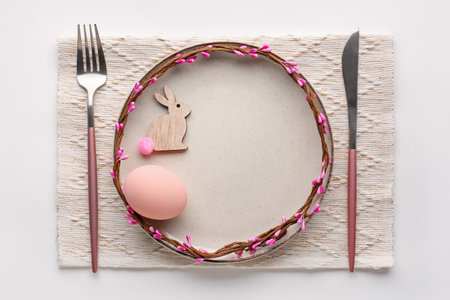Table setting with Easter egg and bunny isolated on white background