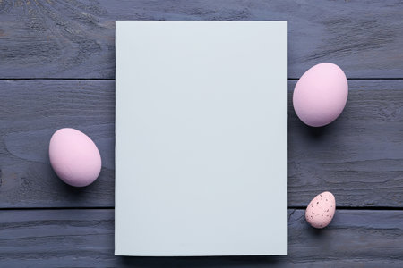 Blank greeting card and Easter eggs on gray wooden backgroundの写真素材